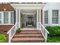 Inviting front porch with brick steps, white columns, and decorative accents at 221 Roebling Ln, Cary, NC 27513