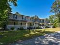 Inviting townhome showcasing covered front porches and lush landscaping, perfect for relaxation at 225 Douglas St, Holly Springs, NC 27540