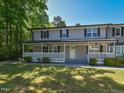 Charming townhome featuring a covered front porch, offering a cozy spot for relaxation at 225 Douglas St, Holly Springs, NC 27540