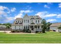 Gorgeous two-story house with a well-kept lawn and a welcoming covered entryway at 2300 Ginger Gold Court, Apex, NC 27539