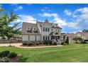 Beautifully designed house with a well-manicured lawn and a covered entryway at 2300 Ginger Gold Court, Apex, NC 27539