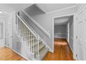 Bright entryway features a carpeted staircase, hardwood floors, and fresh neutral paint throughout at 2301 Pastille Ln, Raleigh, NC 27612