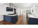 Modern kitchen with stainless steel appliances, white countertops, and dark blue cabinetry at 2318 E Main St, Durham, NC 27703