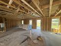Exposed framing showcases the open floor plan, with natural light from the windows at 29 Chloe Ct, Selma, NC 27576