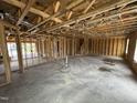 Open-concept living room with exposed beams, a staircase and windows for lots of natural light at 29 Chloe Ct, Selma, NC 27576