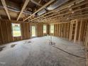 Spacious living room framing, features large windows for natural light and rear door access at 29 Chloe Ct, Selma, NC 27576