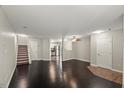 Bright living room features dark hardwood floors, neutral walls, and stairs to the upper level at 2920 Barrymore St # 106, Raleigh, NC 27603