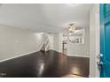 Inviting living room with dark hardwood floors, a staircase, and an opening leading to the kitchen at 2920 Barrymore St # 106, Raleigh, NC 27603