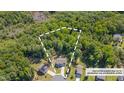 Aerial view of a home surrounded by lush trees, showcasing the expansive property lines at 40 Otter Ct, Youngsville, NC 27596