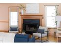 Cozy living room featuring a classic fireplace, hardwood floors, and comfortable seating arrangement with natural light at 404 Denton St, Durham, NC 27713