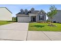 Two-story home with gray siding, manicured lawn, and a concrete driveway at 404 Porterfield Dr, Youngsville, NC 27596