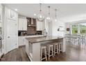 Bright kitchen featuring a large island with seating, pendant lighting, and modern appliances at 404 Porterfield Dr, Youngsville, NC 27596