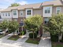 Street view of townhomes featuring neat landscaping and attached garages for convenient parking at 4124 Sykes St, Cary, NC 27519