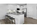 Charming eat-in kitchen featuring granite countertops, stainless steel appliances, and counter seating at 42 Channel Drop Dr, Clayton, NC 27520
