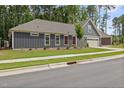 Beautiful home exterior featuring modern siding, brick accents, manicured lawn, and a two-car garage at 428 Crayton Oak Dr, Cary, NC 27519