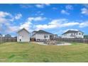 Expansive backyard showcasing an in-ground pool, patio area for outdoor dining, and privacy fencing for leisure and entertainment at 450 S Parliament Way, Clayton, NC 27520