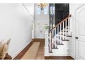 Elegant foyer with high ceilings, chandelier, hardwood floors, and staircase at 4621 Basilica Dr, Holly Springs, NC 27540
