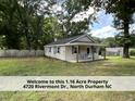 Quaint home with a welcoming porch and a spacious front yard at 4720 Rivermont Rd, Durham, NC 27712