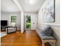 Bright foyer with hardwood floors and stylish bench at 4909 Brookhaven Dr, Raleigh, NC 27612