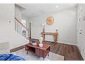 Inviting living room showcasing hardwood floors, modern decor, and an open staircase at 509 Rain Drizzle Ct, Wake Forest, NC 27587