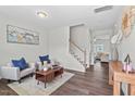 Bright living room featuring stylish decor, hardwood floors, and an open staircase at 509 Rain Drizzle Ct, Wake Forest, NC 27587
