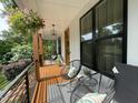 Inviting front porch featuring cozy seating, hanging plants, and a stylish outdoor space at 517 Bart St, Raleigh, NC 27610