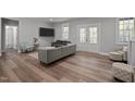 Living room with wood floors, a cozy couch, and natural light, creating a comfortable living space at 5402 Shealtiel Way, Rougemont, NC 27572