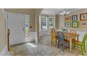 Bright dining area with tiled floor, colorful chairs, and bay window at 5603 Whisperwood Dr, Durham, NC 27713