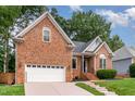 Beautiful brick home with manicured lawn, lovely landscaping and attached garage at 6313 Belle Crest Dr, Raleigh, NC 27612