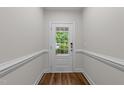 Bright entryway with white trim, a glass-paneled door, and stylish flooring at 640 Barneswyck Dr, Fuquay Varina, NC 27526