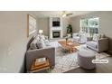 Cozy living room with a fireplace, comfortable seating, and stylish decor. (Virtually staged) at 6701 Winding Arch Dr, Durham, NC 27713
