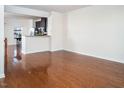 Open-concept living room with hardwood floors and plenty of natural light at 732 Suffield Way, Cary, NC 27519