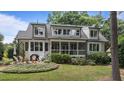 Inviting backyard featuring a cozy patio and manicured landscaping with mature plantings at 763 Heritage Arbor Dr, Wake Forest, NC 27587