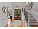 Bright foyer featuring hardwood floors, staircase, and large front doors with sidelights at 763 Heritage Arbor Dr, Wake Forest, NC 27587