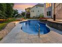 Inground pool features a stone waterfall and spa with views of the backyard at 825 Highwater Pl, Fuquay Varina, NC 27526