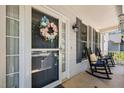Charming front porch with rocking chairs and floral wreath on the front door at 907 Stuart Dr, Mebane, NC 27302