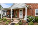 Inviting front porch with detailed trim, seating, and manicured landscaping at 9964 N Chestnut St, Middlesex, NC 27557