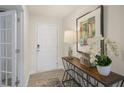 Bright entryway with a front door, an artful wood console table, decor and wood-look flooring at 100 Reagan Crest Dr, Clayton, NC 27520