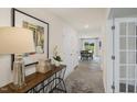 Bright entryway featuring console table, artwork, a front door, and a view to the dining room at 100 Reagan Crest Dr, Clayton, NC 27520