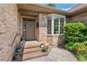 Inviting brick front entrance with charming potted plants and a cozy doorway at 104 Cedar Ridge Way, Durham, NC 27705