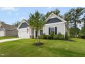 Exterior shot showing the landscaped yard, siding, and trim details of this single-Gathering home at 107 Altair Ln, Sanford, NC 27330