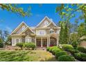 Charming two-story home featuring stone accents, manicured landscaping and inviting entrance at 10909 Grand Journey Ave, Raleigh, NC 27614