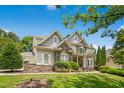 Attractive two-story home with stone accents, lush landscaping, and well-maintained lawn at 10909 Grand Journey Ave, Raleigh, NC 27614
