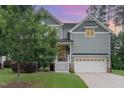 Charming two-story home with a welcoming front porch, manicured lawn and attached two car garage at 1138 Bexley Hills Bnd, Apex, NC 27502