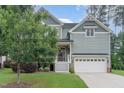 Charming two-story home with a welcoming front porch, manicured lawn and attached two car garage at 1138 Bexley Hills Bnd, Apex, NC 27502