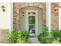 Inviting front entrance with a stone archway and well-manicured landscaping at 1213 Silver Beach Way, Raleigh, NC 27606