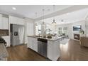 Open kitchen featuring an island with stainless steel appliances and granite countertops at 129 Explorer Dr # 256, Morrisville, NC 27560
