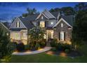 Charming exterior view of a home featuring stone accents and a well-maintained front yard at 1325 Mackinaw Dr, Wake Forest, NC 27587