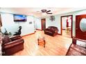 Inviting living room with laminate floors, ceiling fan, and comfortable leather furnishings at 1337 Maple St, Rocky Mount, NC 27803