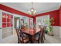 Formal dining room featuring a beautiful chandelier, decorative painting, a large table, and bright windows at 15 Smoketree Ct, Durham, NC 27712